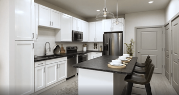a kitchen with white cabinets and a black counter top